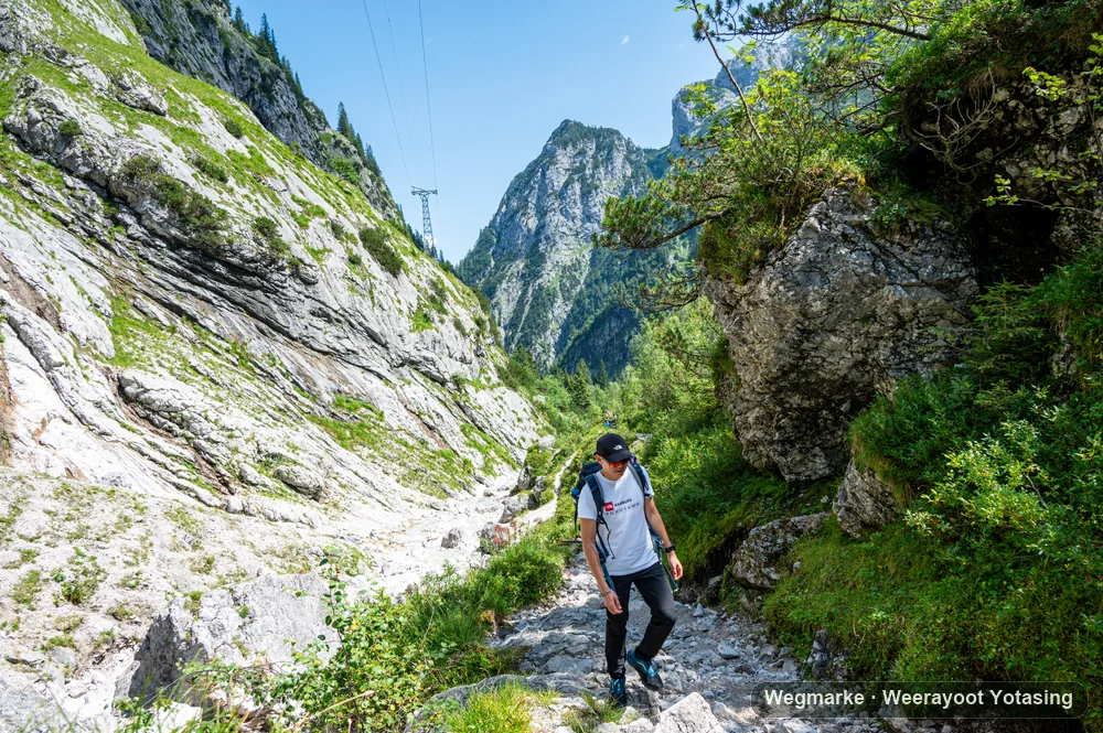 Hiker moving between rock walls