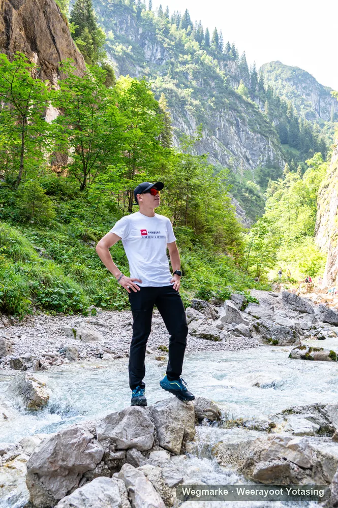 A hiker looking back from a rocky trail